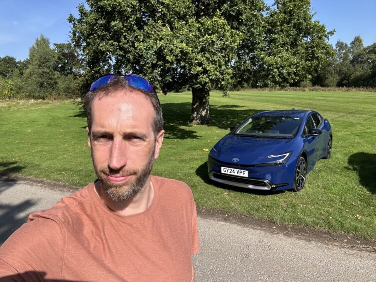 Jack McKeown takes a selfie with the car in the background