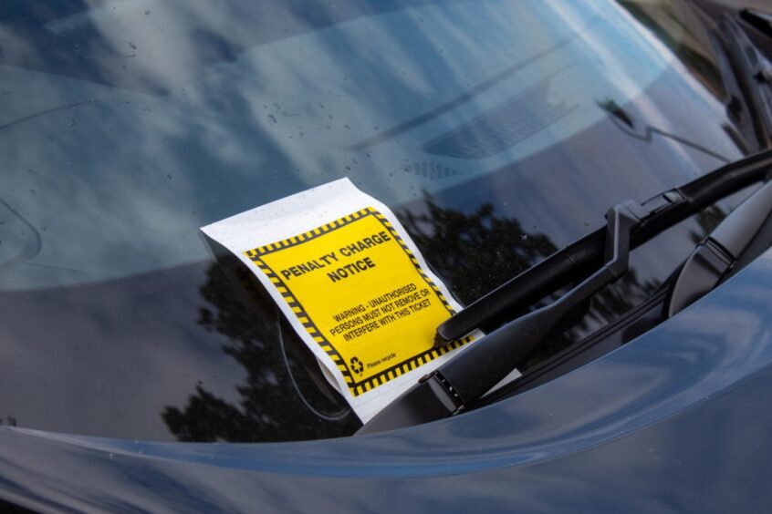 A parking ticket on a car.