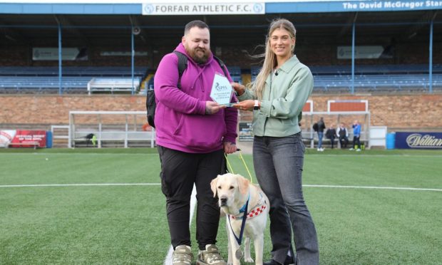 Jon Attenborough and guide dog Sam being presented with awards by the SPFL’s Molly Hyde after Saturday’s match.