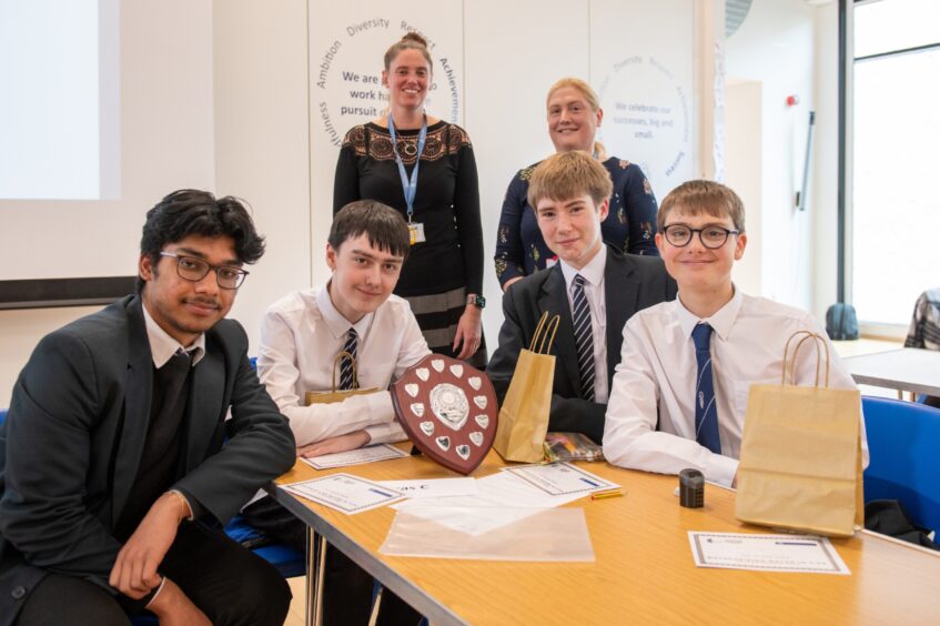 The winning team of four with their trophy and two of the organising teachers at Enterprising Maths Fife 2024