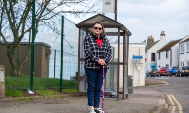 Kim Rennie waits at the main bus stop in Ferryden near Montrose.