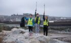 Litter pickers at the ready for Ladyloan pupils (from left) Cara Gillespie, Mason Millar and Ethen Mackie. Image: Kim Cessford / DC Thomson