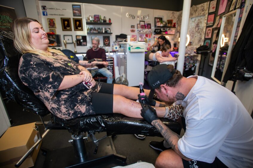 Liam tattooing his wife Aimee at Carpe Diem Tattoo Studio in Dundee.