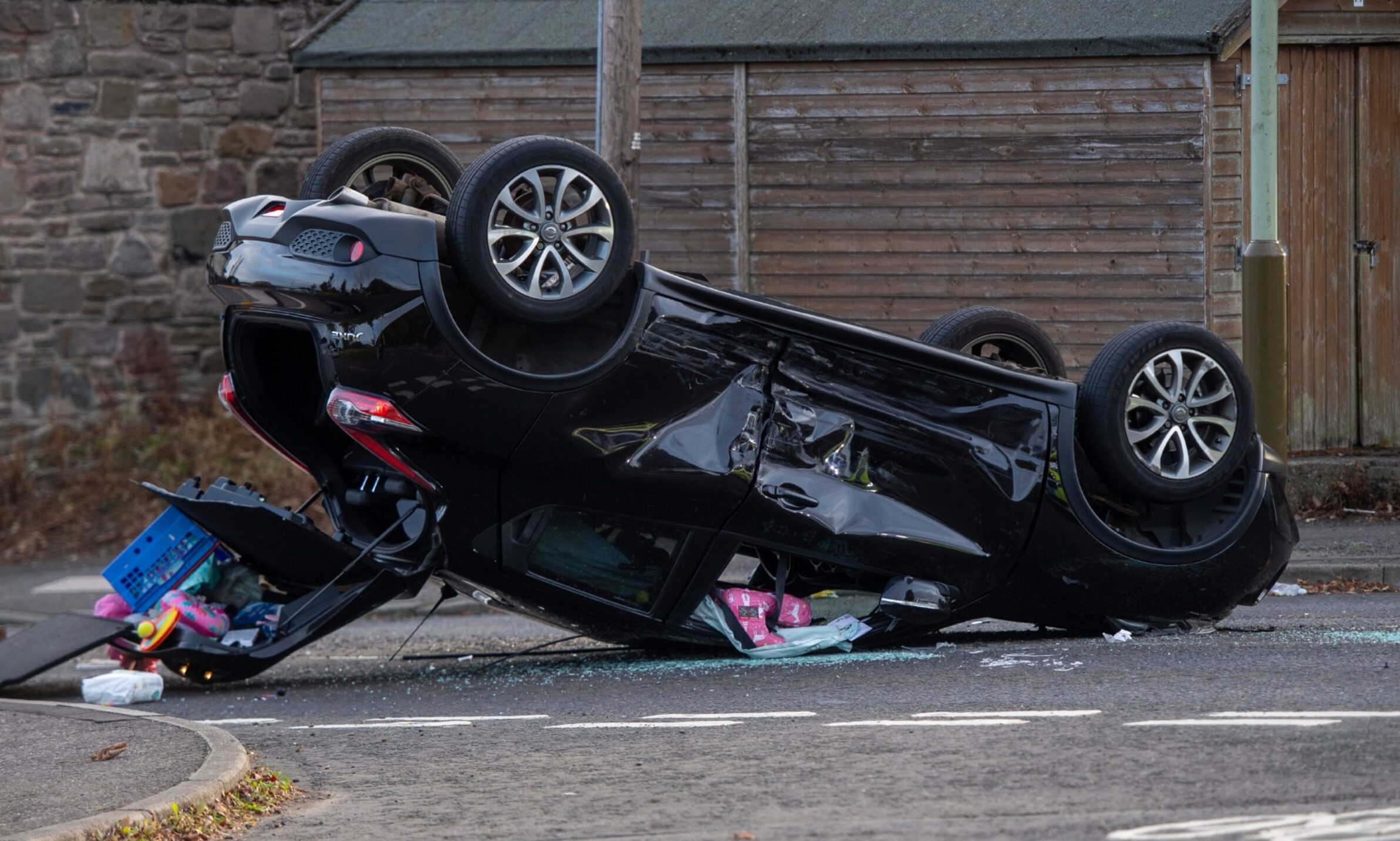 The car on its roof on Strips of Craigie Road. Image: James Simpson/DC Thomson