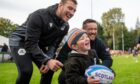 Douglas Cooper loved getting his rugby ball signed by Scotland rugby stars Zander and Matt Fagerson. Image: Kim Cessford / DC Thomson