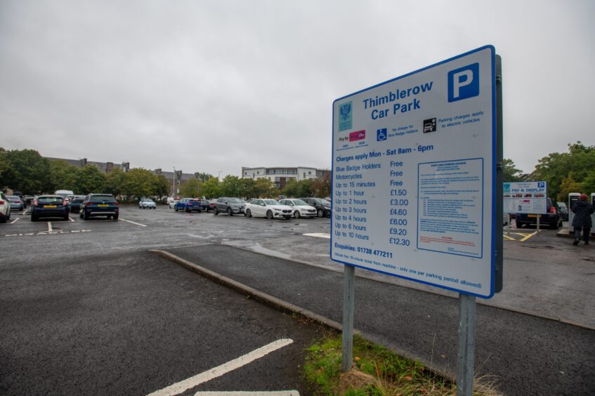 Thimblerow car park with sign in foreground and parked cars behind