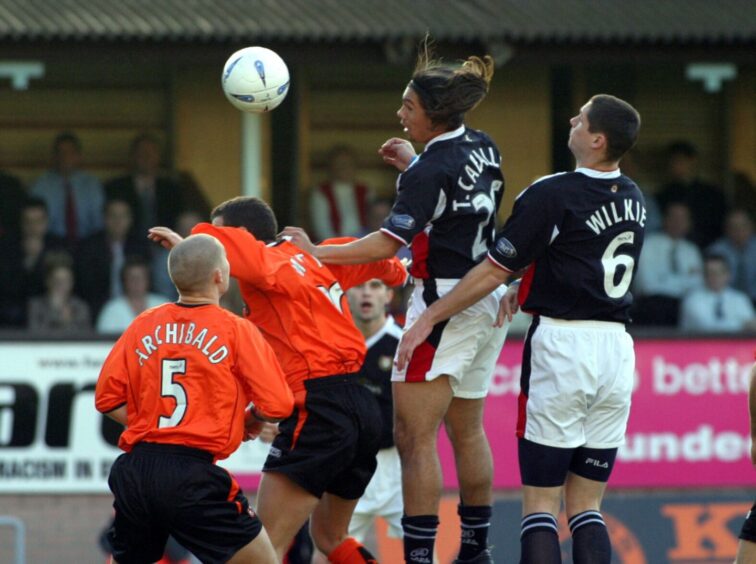 Fabian Caballero beats Dundee team-mate Lee Wilkie to a header against Dundee United. Image: SNS