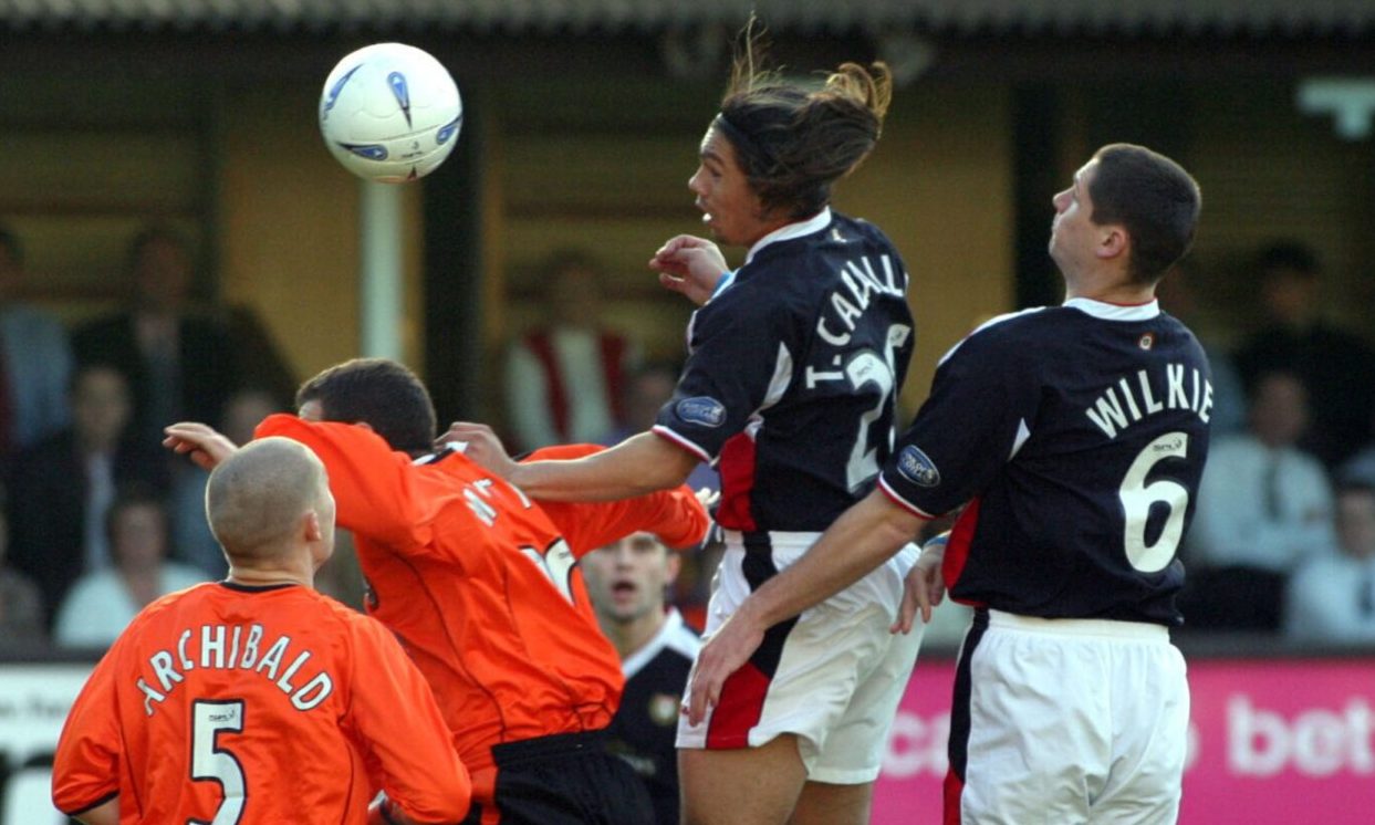 Fabian Caballero beats Dundee team-mate Lee Wilkie to a header against Dundee United. Image: SNS