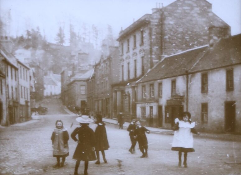 Children playing in street in Dunkeld in turn of 20th century clothing