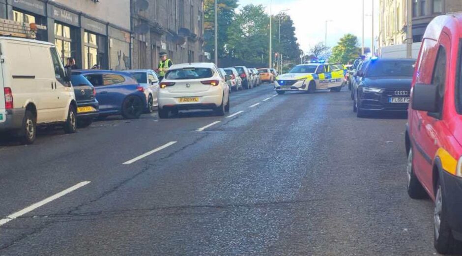 Another view of police at the scene on Strathmartine Road in Dundee.