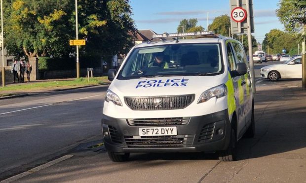 A police van outside the house on Arbroath Road, Dundee, following a car fire. Image: Andrew Robson/DC Thomson