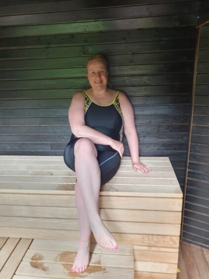 Debbie pictured inside the outdoor sauna.