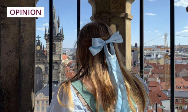 Rebecca looks out over the city of Prague from the tower of its Astronomical Clock. Image: Supplied/DC Thomson.