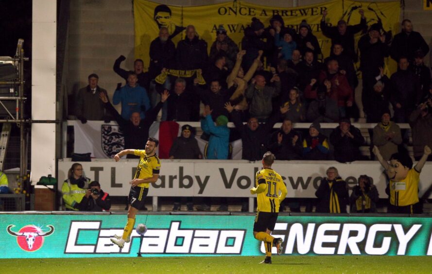 Scott Fraser celebrates a cup strike for Burton against Nottingham Forest