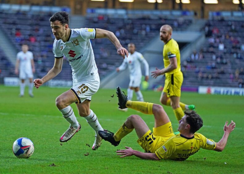 the former United midfielder goes past an opponent, who is lying on the pitch, while playing in England 