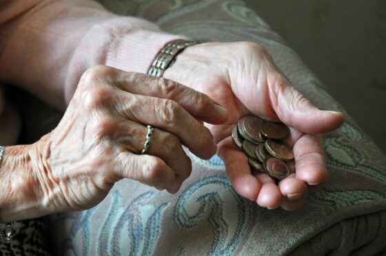 Old woman holding coins