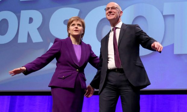 First Minister Nicola Sturgeon with Deputy First Minister John Swinney after he delivered his speech at the SNP conference in Glasgow.  PRESS ASSOCIATION Photo. Picture date: Friday October 14, 2016. See PA story POLITICS SNP.  Photo credit should read: Jane Barlow/PA Wire