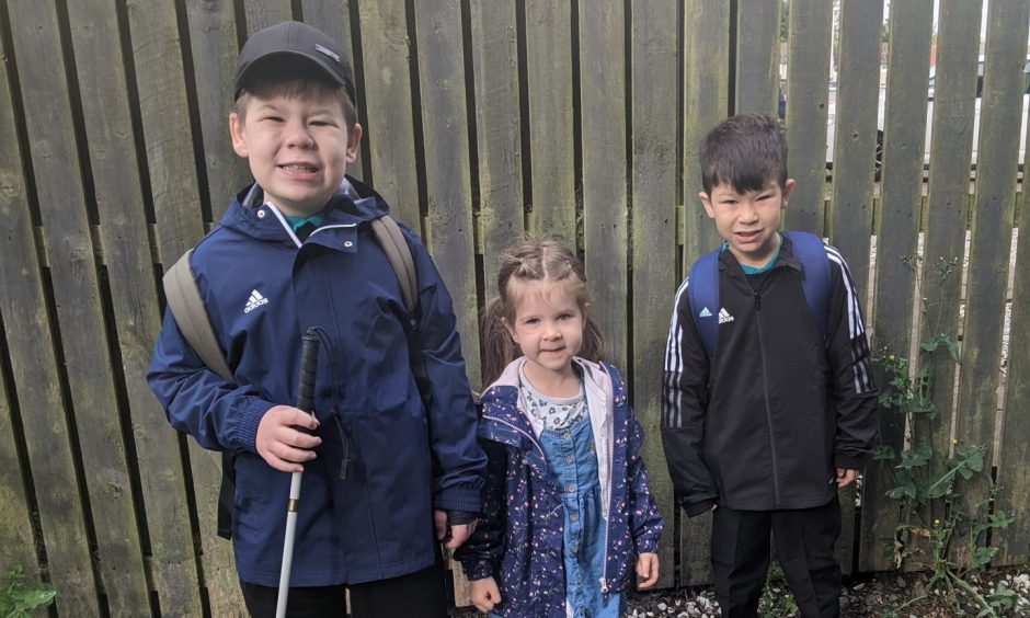 Harry (left) with sister Olivia and brother Charlie.