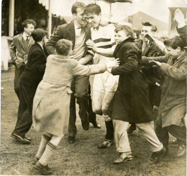 Ron Yeats is mobbed by fans following Dundee United's promotion