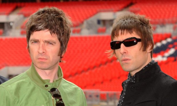 Noel and Liam Gallagher, of Oasis, in an empty stadium.