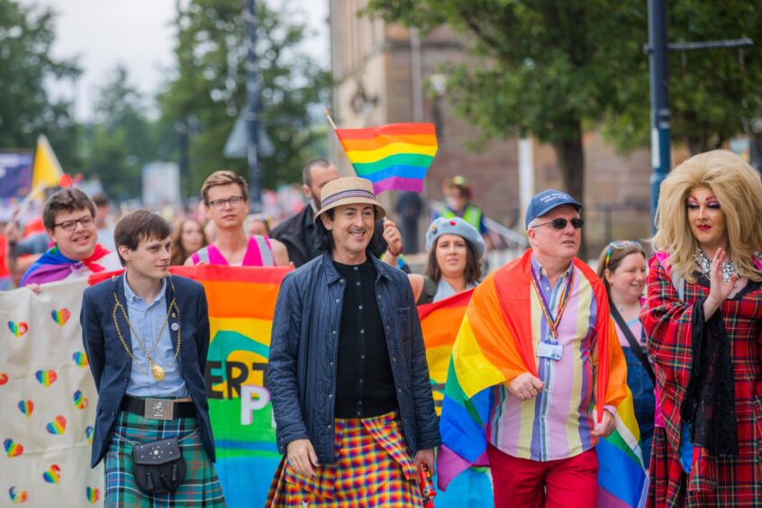 Alan Cumming and Perth provost Xander McDade walking at front of Perthshire pride march