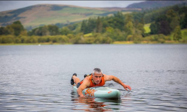 Blind prone paddleboarder Dean Dunbar training at Clunie Loch near Blairgowrie. Image: Steve MacDougall/ DC Thomson.