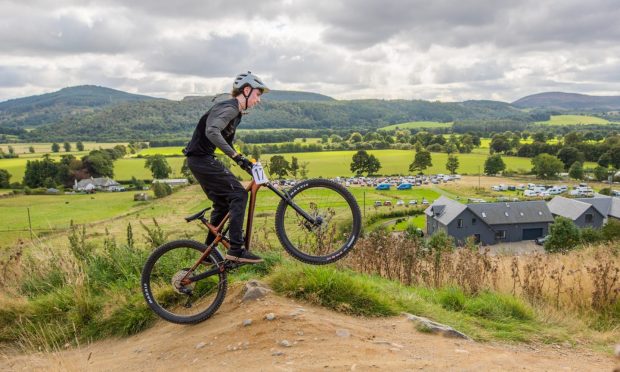 BESTPIC CR0049839  - Cheryl Peebles Story  - Perthshire area  - Morrisons Academy are hosting the Scottish Schools Mountain Bike Championships for the second year at Comrie Croft -- Picture shows action from the event girls and boys S3/4 race - getting air is Sandy Crighton (Blairgowrie High School)
 -- ok to be named as checked with his school directly   --- Comrie Croft, Comrie - Thursday 12th September 2024  - Image: Steve MacDougall/DC Thomson