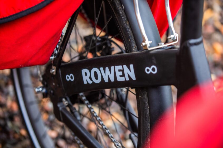 Close up of word 'Rowen' in white on frame of black trishaw