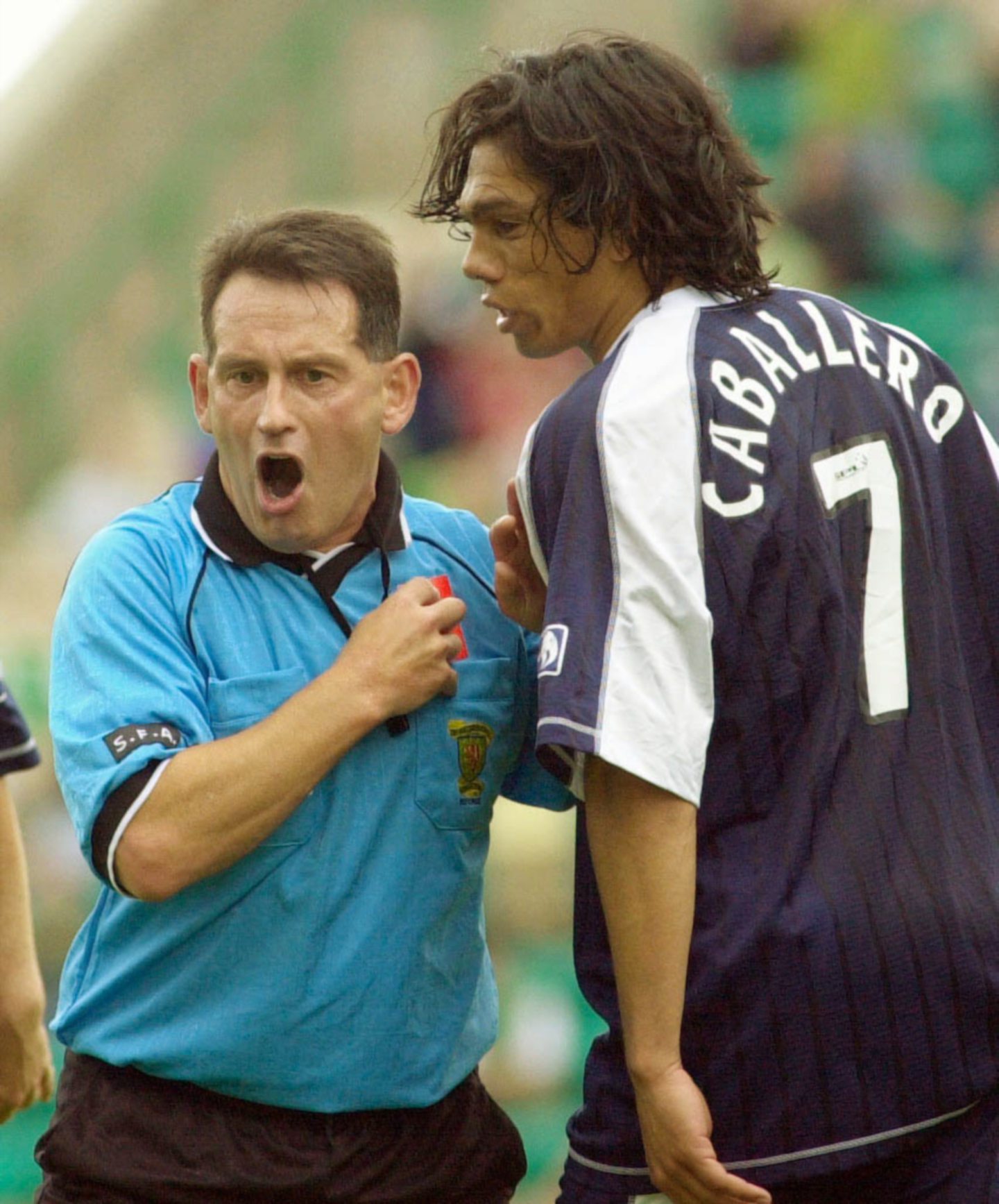 Referee George Clyde gives an angry Fabian Caballero the red card at Easter Road.