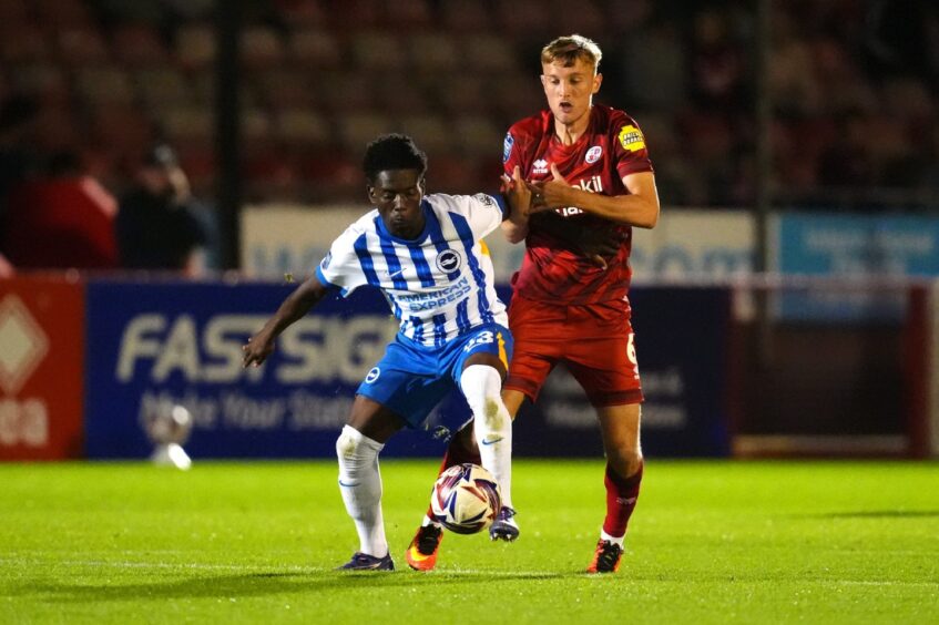 Max Anderson in action for Crawley Town against Brighton. Image: PA