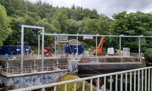 Large metal structure over river in St Fillans