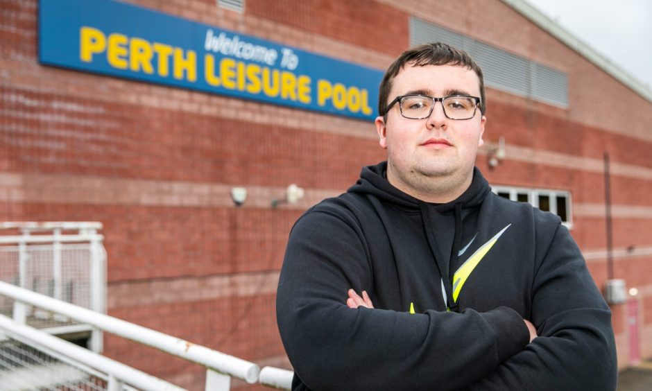 Bobby Brian, arms folded in front of sign for Perth Leisure Pool