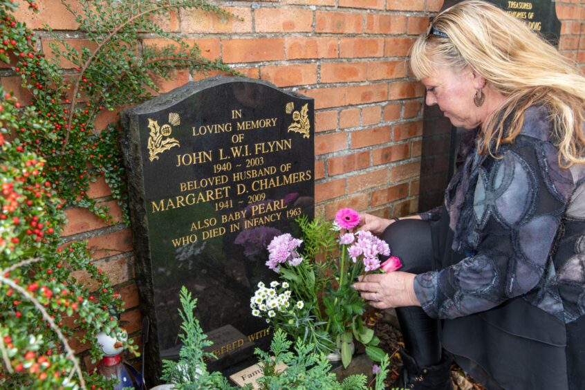 Caroline tends her parents' grave in Scoonie Cemetery, Leven. She says Fife parents of stillborn babies deserve answers