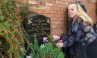 Caroline Mitchell at her parent's grave in Scoonie Cemetery, which also bears Pearl's name.