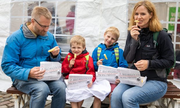 The Corah family from Nottingham enjoying a fish supper while on holiday in Anstruther in 2018. Dad Peter, Ethan (4), Sam (7) and mum Helen. But should they face a tourist tax? Image: DC Thomson