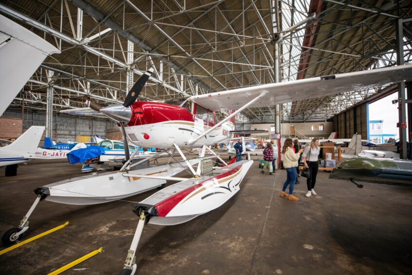 Seaplane and others inside hangar at Perth airport