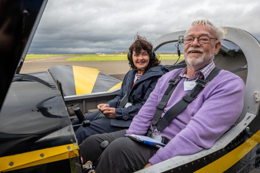 Courier reporter Morag Lindsay seated inside cockpit alongside Keith Boardman on runway at Peth airport.