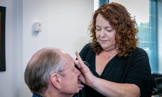 Sarah Jardine at Epipole in Rosyth, demonstrating the epiCam portable Retina Scanner. Image: Steve Brown/DC Thomson