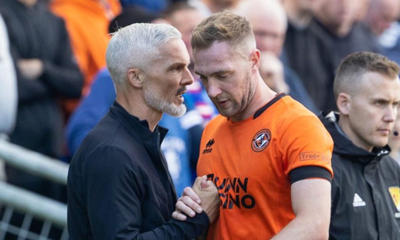 Holt, right, receives some conciliatory words from boss Jim Goodwin