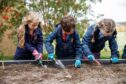 Students digging and learning outside at St Leonards School.