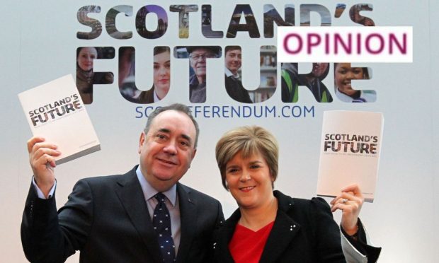 Alex Salmond and Nicola Sturgeon hold copies of the White Paper in November 2013. Image: Andrew Milligan/PA Wire