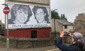 Nicky Riding takes a photo of the Wham! billboard in Dundee. Image: James Simpson/DC Thomson