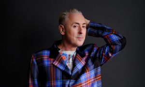 Alan Cumming in tartan suit.