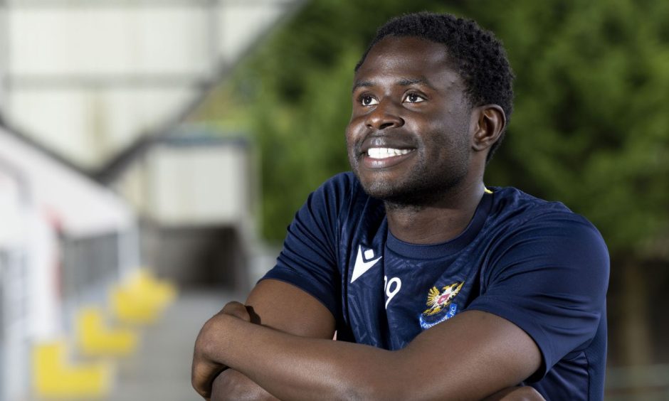 A smiling Benji Kimpioka in a St Johnstone training top.