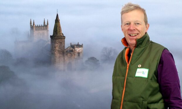 Thomas Haywood with one of his shots of Dunfermline Abbey. Image: FSB