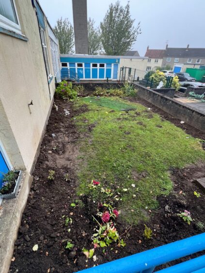 Our Lady's School garden with plans dug up and thrown over grass