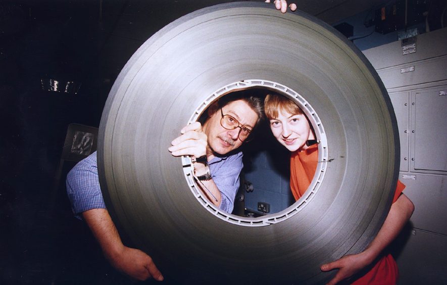 Bob Vettraino and Ness Wilson with the old copy of Lethal Weapon, a reel so big they can both look the hole in its centre