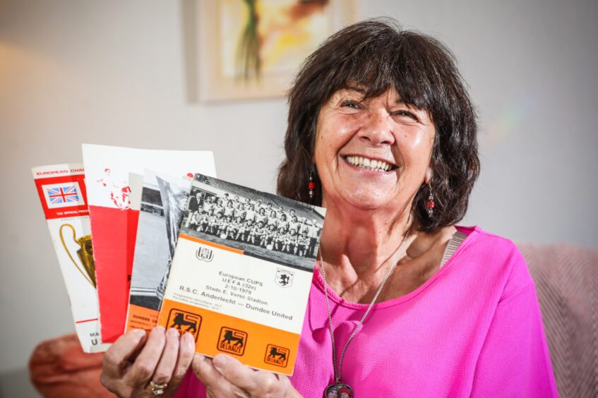 A smiling Amanda Kopel shows off some mementoes from Frank's career. 