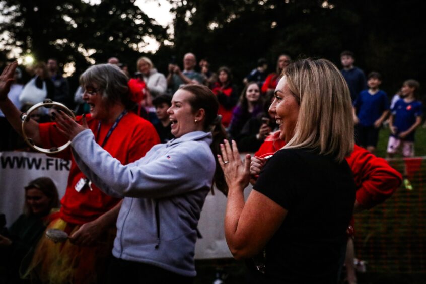 People cheering and laughing at firewalk