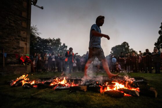 Person walking across flaming coals